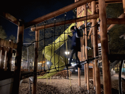 Max on a rope bridge at the main playground at the Landal Coldenhove holiday park, by night