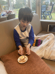 Max eating a boiled egg in the living room of our holiday home at the Landal Coldenhove holiday park