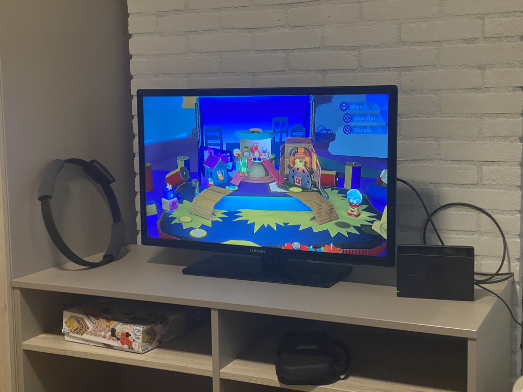 TV screen with the Nintendo Switch game `Yoshi`s Crafted World` in the living room of our holiday home at the Landal Coldenhove holiday park