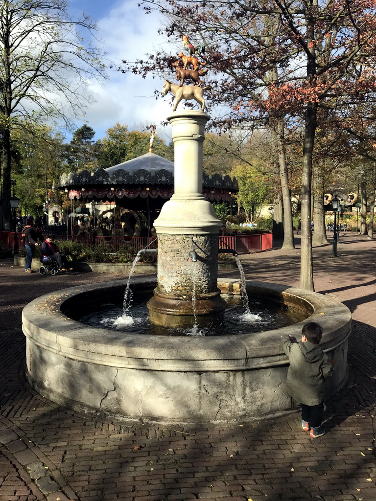 Max at the Town Musicians of Bremen fountain at the Anton Pieck Plein square at the Marerijk kingdom