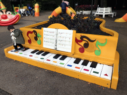 Max on a piano at the Kleuterhof playground at the Reizenrijk kingdom