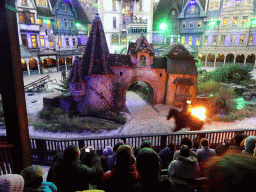 Actor, horse and fire on the stage of the Raveleijn theatre at the Marerijk kingdom, during the Raveleijn Parkshow at the Winter Efteling, at sunset