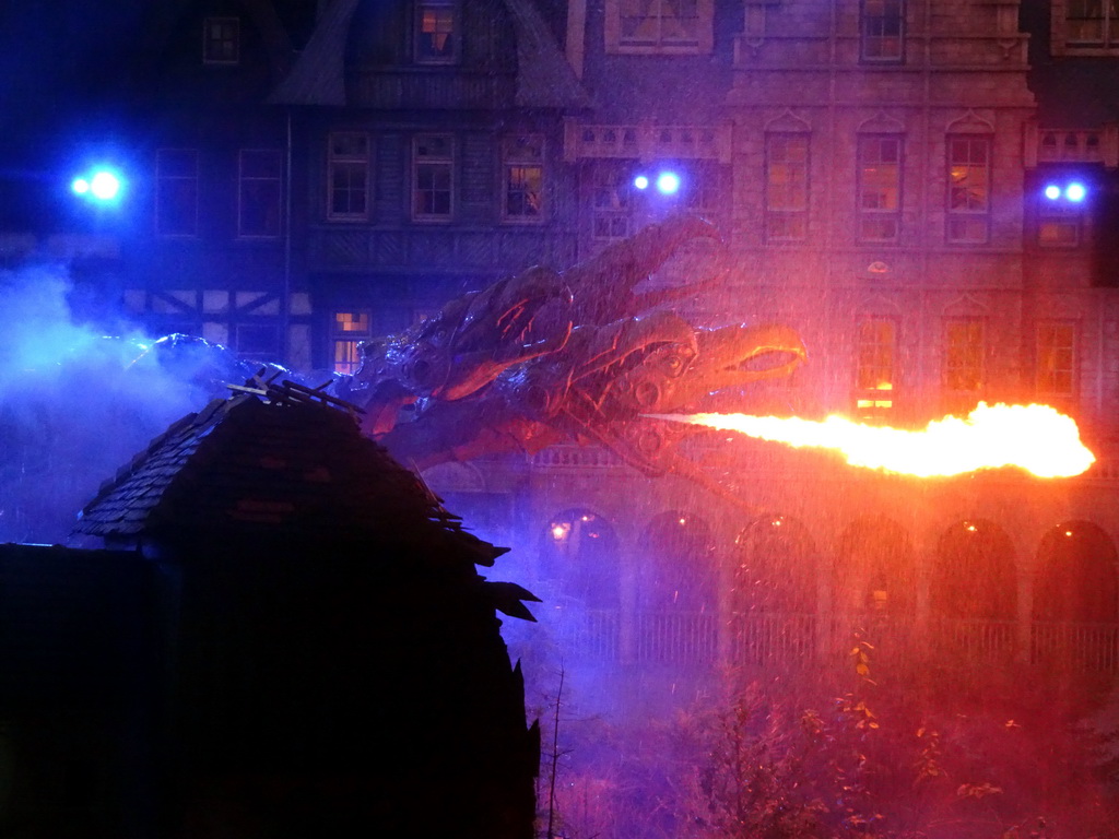 Dragon, water and fire on the stage of the Raveleijn theatre at the Marerijk kingdom, during the Raveleijn Parkshow at the Winter Efteling, at sunset