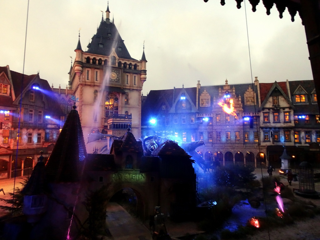 Dragon, actors, horses, water and fire on the stage of the Raveleijn theatre at the Marerijk kingdom, during the Raveleijn Parkshow at the Winter Efteling, at sunset