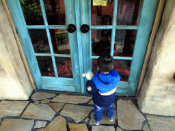 Max in front of Geppetto`s House at the Pinocchio attraction at the Fairytale Forest at the Marerijk kingdom, during the Winter Efteling