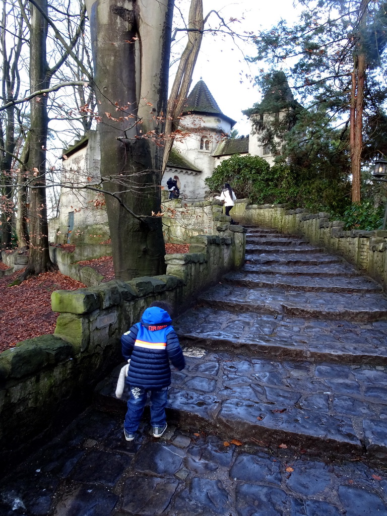 Max on the staircase to the Castle of Sleeping Beauty at the Sleeping Beauty attraction at the Fairytale Forest at the Marerijk kingdom, during the Winter Efteling
