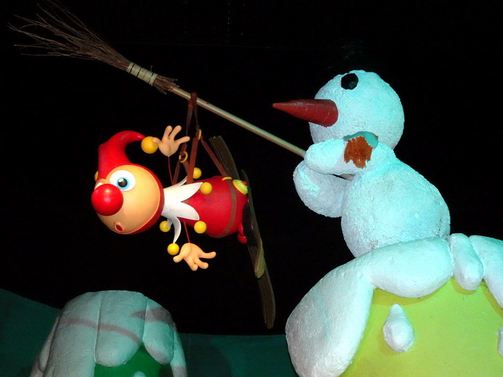 Jokie and a snowman at the Swiss scene at the Carnaval Festival attraction at the Reizenrijk kingdom, during the Winter Efteling