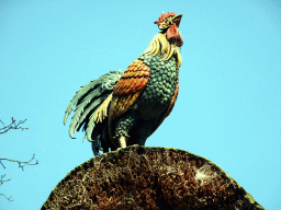 Rooster on top of the house at the Mother Holle attraction at the Fairytale Forest at the Marerijk kingdom