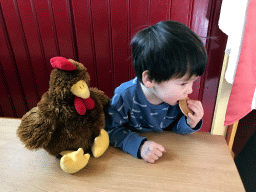 Max with a stuffed chicken and a stroopwafel at the `t Poffertje restaurant at the Anton Pieck Plein square at the Marerijk kingdom