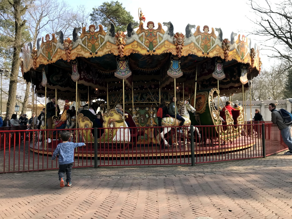 Max in front of the Vermolen Carousel at the Anton Pieck Plein square at the Marerijk kingdom