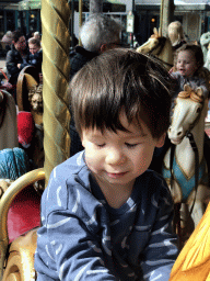 Max on a rooster statue at the Vermolen Carousel at the Anton Pieck Plein square at the Marerijk kingdom