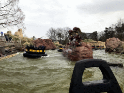 Inca statues and boats at the Piraña attraction at the Anderrijk kingdom, viewed from a boat