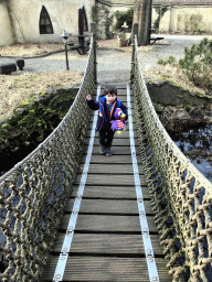 Max with stuffed animal Jet on the walkway at the Lijn`s Zweefhuys building at the Laafland attraction at the Marerijk kingdom