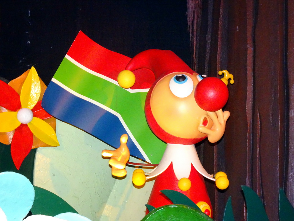 Jokie with a South-African flag at the African scene at the Carnaval Festival attraction at the Reizenrijk kingdom