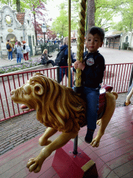 Max on a lion statue at the Vermolen Carousel at the Anton Pieck Plein square at the Marerijk kingdom