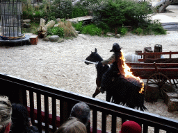 Actor and horse on fire on the stage of the Raveleijn theatre at the Marerijk kingdom, during the Raveleijn Parkshow