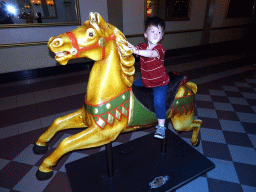 Max on a horse statue in front of the Stoomcarrousel attraction at the Marerijk kingdom