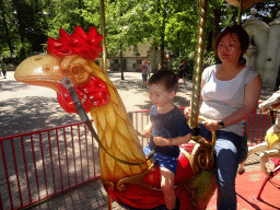 Miaomiao and Max on a rooster statue at the Vermolen Carousel at the Anton Pieck Plein square at the Marerijk kingdom