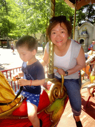 Miaomiao and Max on a rooster statue at the Vermolen Carousel at the Anton Pieck Plein square at the Marerijk kingdom