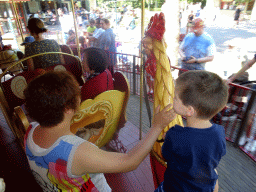 Miaomiao, Max and Miaomiaos`s mother at the Vermolen Carousel at the Anton Pieck Plein square at the Marerijk kingdom