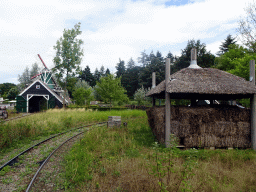 Windmills and sheds at the Kinderspoor attraction at the Ruigrijk kingdom, viewed from the train