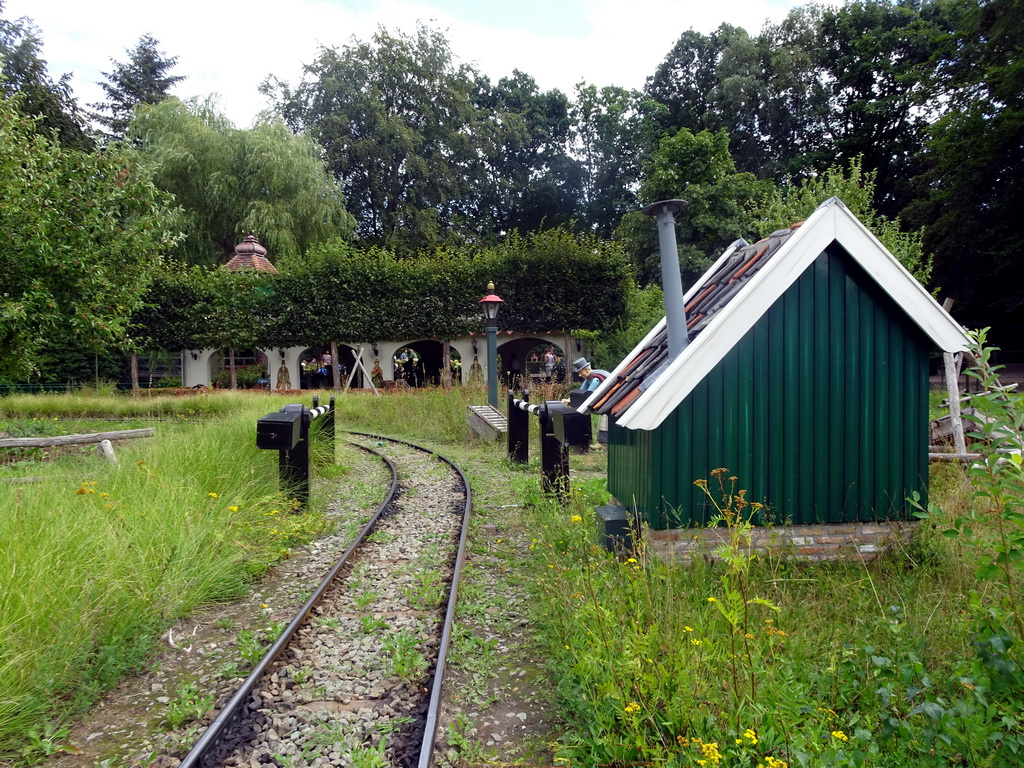 Shed and railroad crossing at the Kinderspoor attraction at the Ruigrijk kingdom, viewed from the train