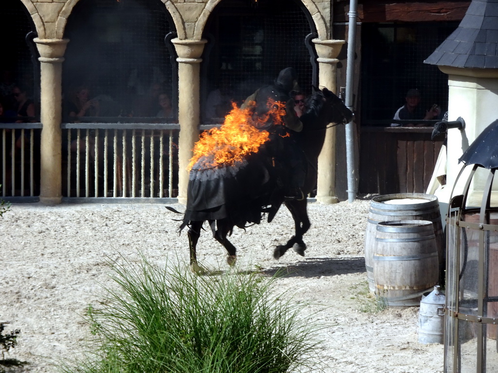 Actor and horse on fire on the stage of the Raveleijn theatre at the Marerijk kingdom, during the Raveleijn Parkshow