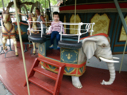 Max on an elephant statue at the Anton Pieck Carousel at the Anton Pieck Plein square at the Marerijk kingdom