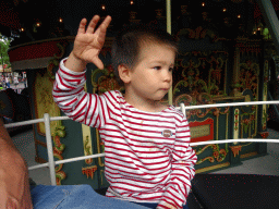 Max on an elephant statue at the Anton Pieck Carousel at the Anton Pieck Plein square at the Marerijk kingdom