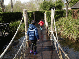 Max and our friend on a bridge with fountains at the Adventure Maze at the Reizenrijk kingdom