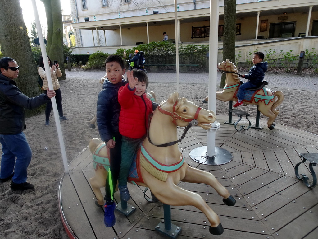 Max and our friends at a carousel at the Kindervreugd playground at the Marerijk kingdom