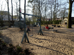 Max and our friend on a swing at the Kindervreugd playground at the Marerijk kingdom