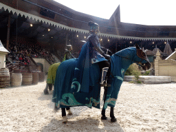 Actors and horses on the stage of the Raveleijn theatre at the Marerijk kingdom, during the Raveleijn Parkshow, viewed from the Wapen van Raveleijn restaurant