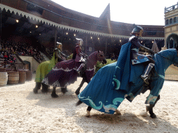 Actors and horses on the stage of the Raveleijn theatre at the Marerijk kingdom, during the Raveleijn Parkshow, viewed from the Wapen van Raveleijn restaurant