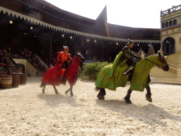 Actors and horses on the stage of the Raveleijn theatre at the Marerijk kingdom, during the Raveleijn Parkshow, viewed from the Wapen van Raveleijn restaurant