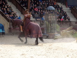 Actors and horses on the stage of the Raveleijn theatre at the Marerijk kingdom, during the Raveleijn Parkshow, viewed from the Wapen van Raveleijn restaurant