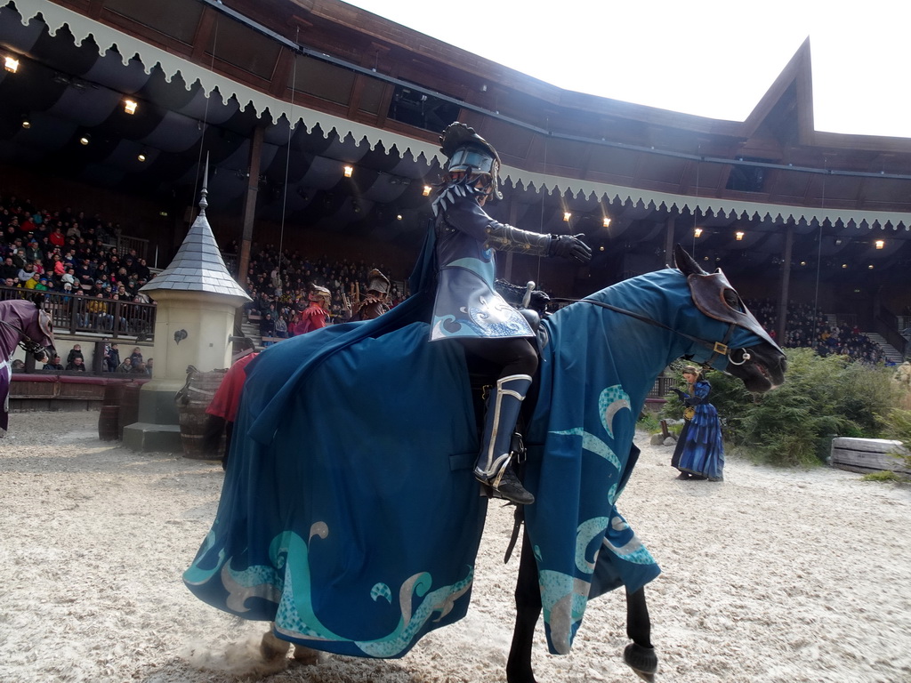 Actors and horses on the stage of the Raveleijn theatre at the Marerijk kingdom, during the Raveleijn Parkshow, viewed from the Wapen van Raveleijn restaurant