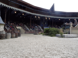 Actors coming down from the ceiling of the grandstand to the stage of the Raveleijn theatre at the Marerijk kingdom, during the Raveleijn Parkshow, viewed from the Wapen van Raveleijn restaurant