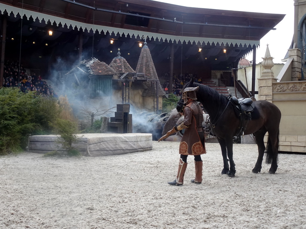 Actor, horse and dragon on the stage of the Raveleijn theatre at the Marerijk kingdom, during the Raveleijn Parkshow, viewed from the Wapen van Raveleijn restaurant