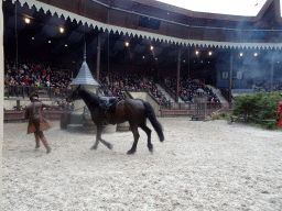 Actors and horse on the stage of the Raveleijn theatre at the Marerijk kingdom, during the Raveleijn Parkshow, viewed from the Wapen van Raveleijn restaurant