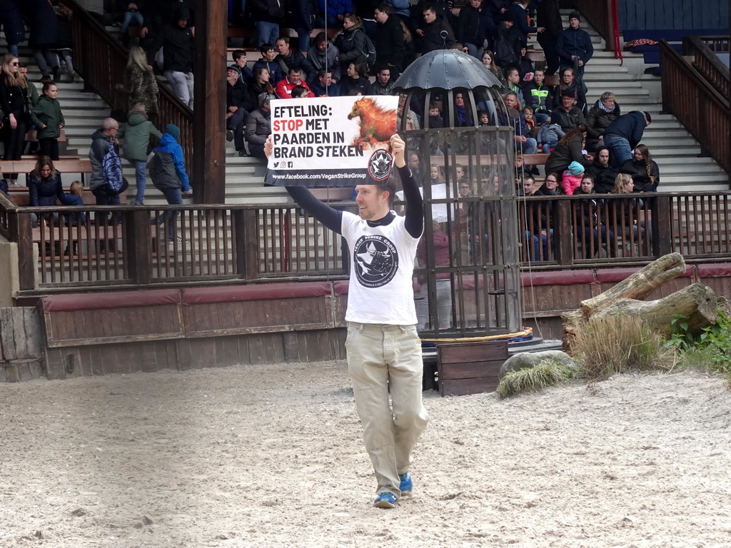 Vegan Strike Group protester on the stage of the Raveleijn theatre at the Marerijk kingdom, during the Raveleijn Parkshow, viewed from the Wapen van Raveleijn restaurant