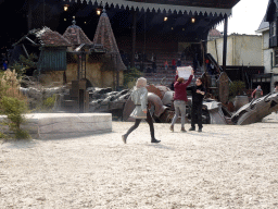 Dragon, actors and Vegan Strike Group protester on the stage of the Raveleijn theatre at the Marerijk kingdom, during the Raveleijn Parkshow, viewed from the Wapen van Raveleijn restaurant