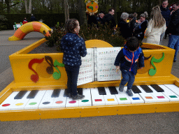 Max on a piano at the Kleuterhof playground at the Reizenrijk kingdom