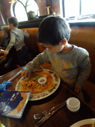 Max eating a pancake at the Polles Keuken restaurant at the Fantasierijk kingdom