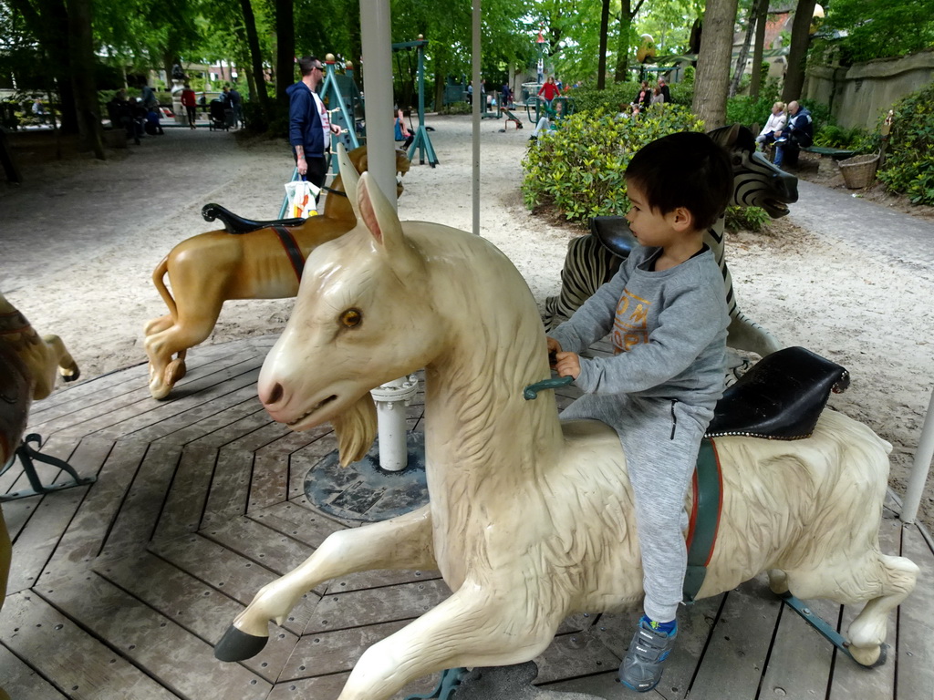 Max on a carousel at the Kindervreugd playground at the Marerijk kingdom