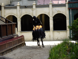Actor and horse on fire on the stage of the Raveleijn theatre at the Marerijk kingdom, during the Raveleijn Parkshow