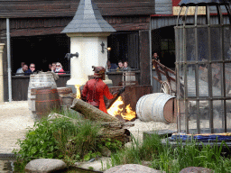 Actor and fire on the stage of the Raveleijn theatre at the Marerijk kingdom, during the Raveleijn Parkshow