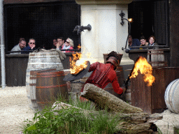 Actor and fire on the stage of the Raveleijn theatre at the Marerijk kingdom, during the Raveleijn Parkshow