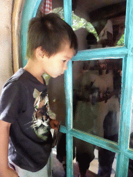 Max looking at Geppetto`s House at the Pinocchio attraction at the Fairytale Forest at the Marerijk kingdom