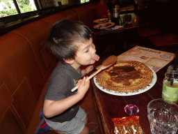 Max eating a chocolate pancake at the Polles Keuken restaurant at the Fantasierijk kingdom